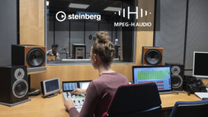 A person working with a mixing console recording a guitarrist.